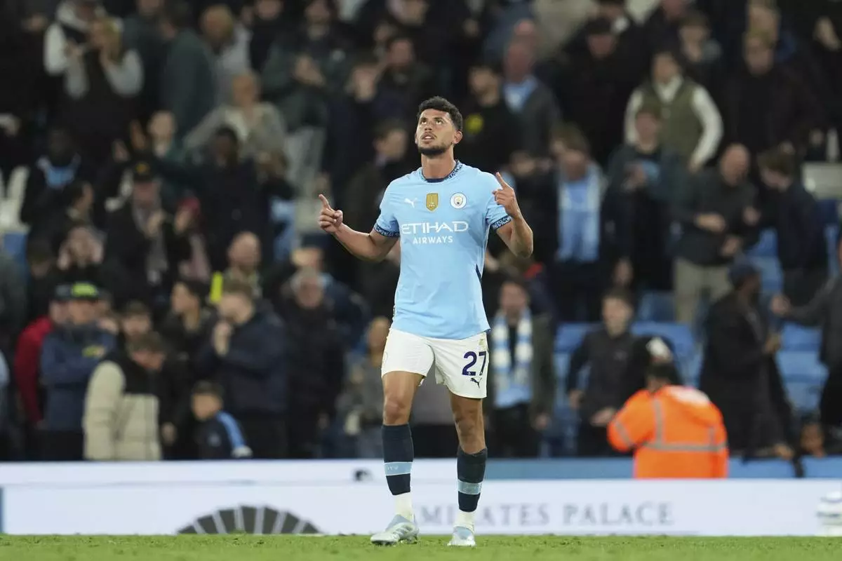 Manchester City's Matheus Nunes celebrates after scoring his side's second goal during the English Premier League soccer match between Manchester City and Aston Villa at Etihad stadium in Manchester, England, Tuesday, April 22, 2025. (AP Photo/Jon Super)