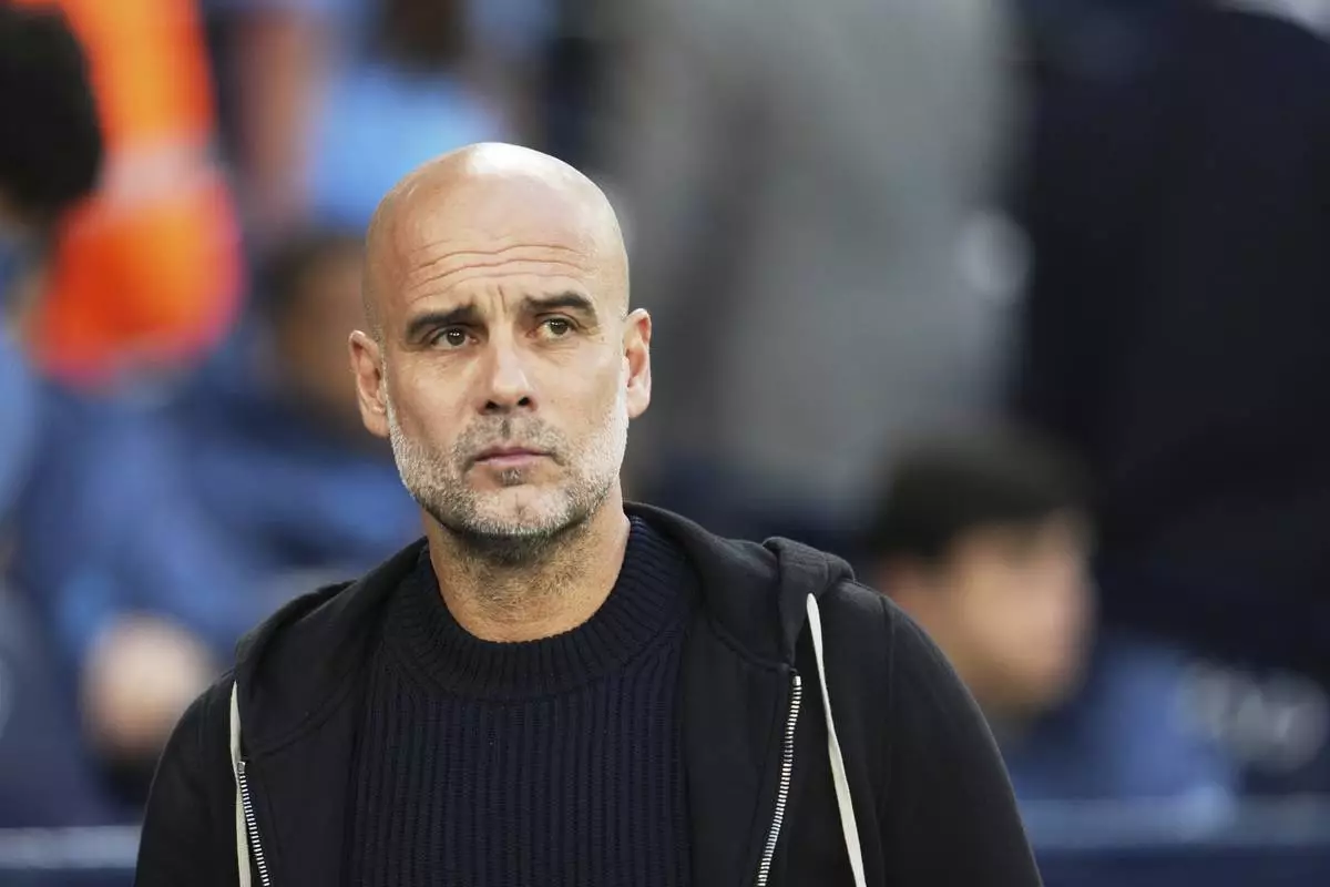 Manchester City's head coach Pep Guardiola waits for the start of the English Premier League soccer match between Manchester City and Aston Villa at Etihad stadium in Manchester, England, Tuesday, April 22, 2025. (AP Photo/Jon Super)
