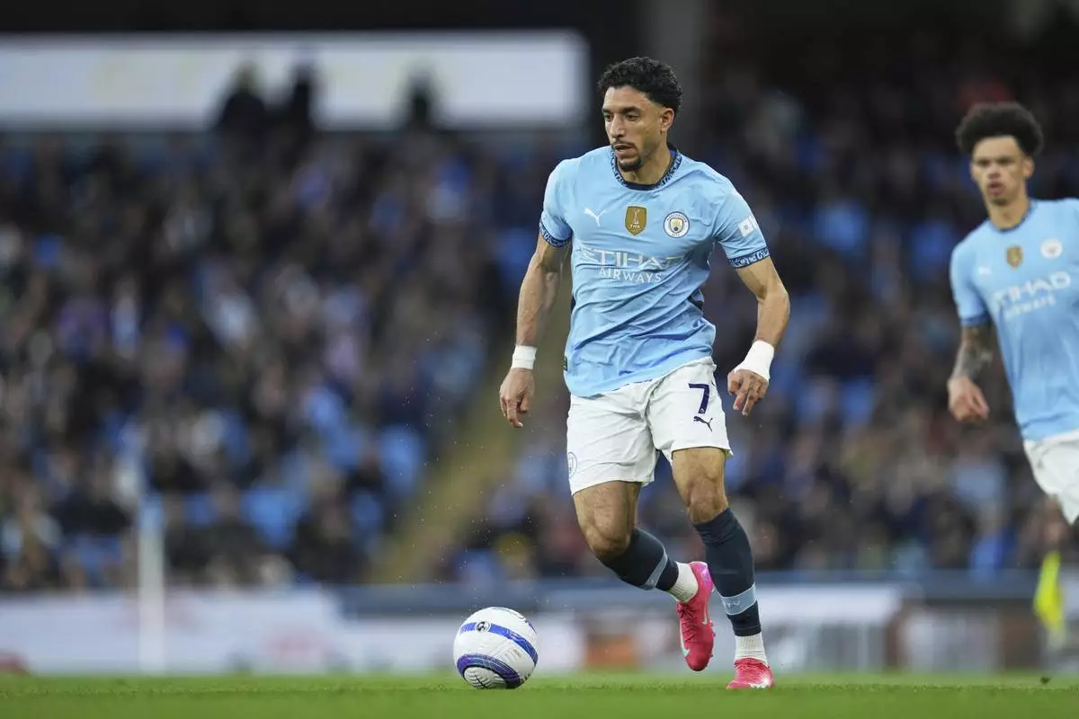 Manchester City's Omar Marmoush in action during the English Premier League soccer match between Manchester City and Aston Villa at Etihad stadium in Manchester, England, Tuesday, April 22, 2025. (AP Photo/Jon Super)