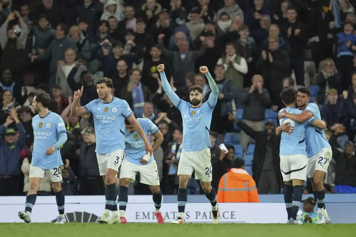 Manchester City players celebrate their victory at the English Premier League soccer match between Manchester City and Aston Villa at Etihad stadium in Manchester, England, Tuesday, April 22, 2025. (AP Photo/Jon Super)