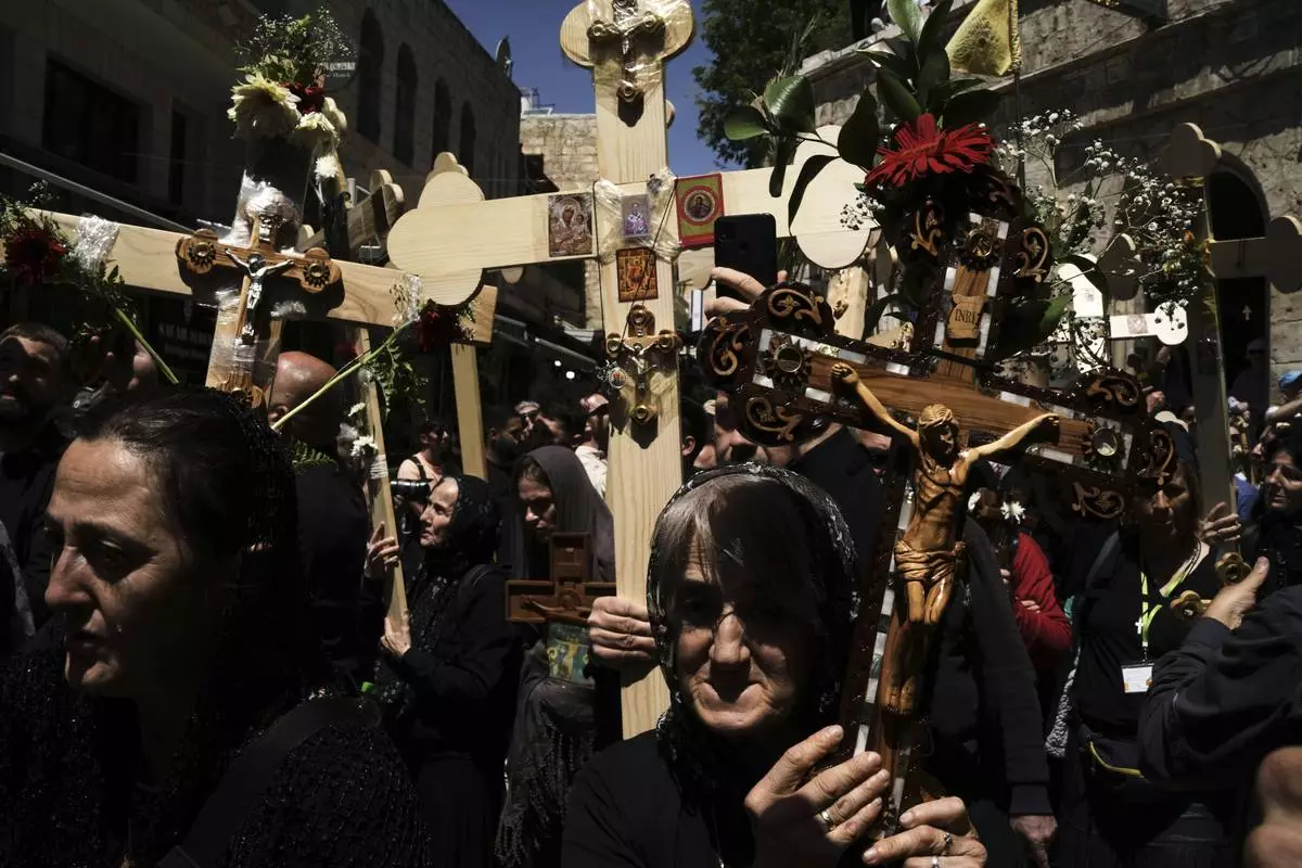 Christian pilgrims carry crosses during a Holy Week procession in the Old City of Jerusalem on Good Friday, April 18, 2025. (AP Photo/Leo Correa)