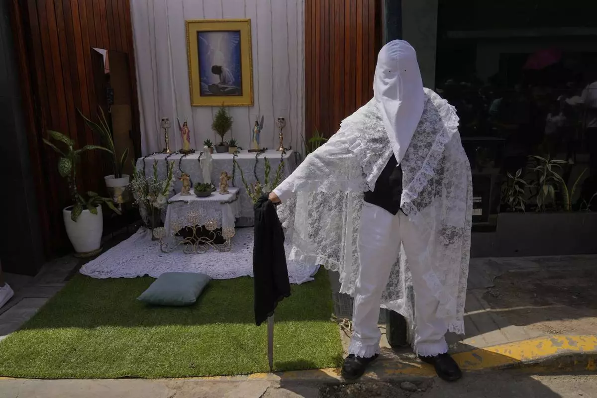 A member of a brotherhood performs in a Way of the Cross reenactment in Pachacamac, Peru, on Good Friday, April 18, 2025. (AP Photo/Martin Mejia)