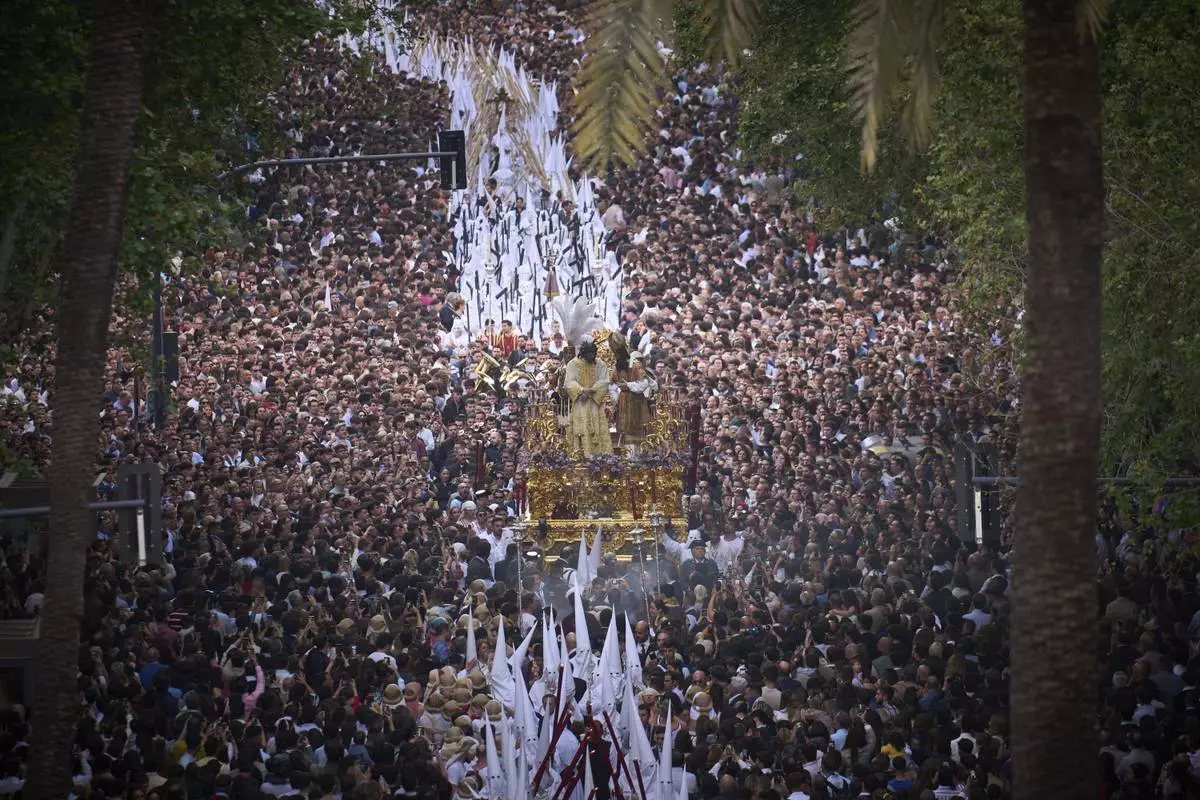 Faithful watch a Holy Week procession by the penitents from the 'San Gonzalo' brotherhood in Seville, Spain, April 14, 2025. (AP Photo/Emilio Morenatti)
