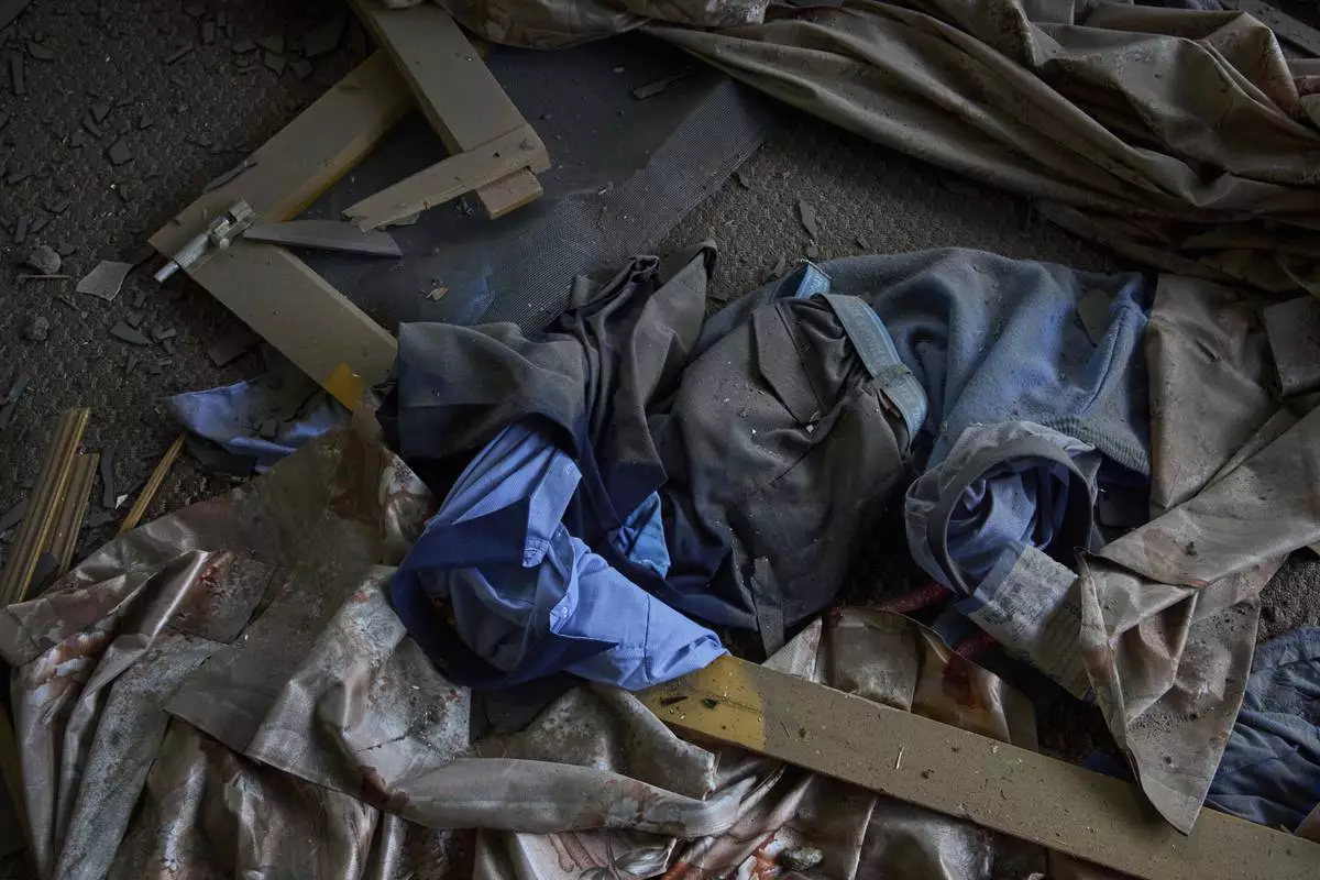 The school uniform lies scattered in a neighbouring house is seen after Indian forces blew up the family home of Ahsan Ul Haq Shiekh, a militant who officials say is involved in the deadly attack on tourists in Pahalgam, at Murran village in Pulwama, south of Srinagar, Indian controlled Kashmir, Saturday, April 26, 2025. (AP Photo/Dar Yasin)
