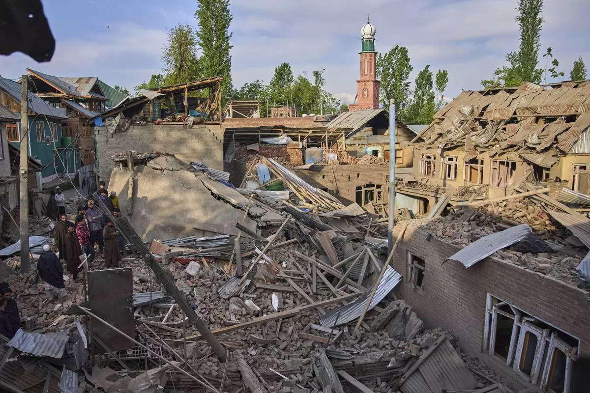 Kashmiri villagers inspect the debris of the blown-up family home of Ahsan Ul Haq Shiekh, a militant who officials say is involved in the deadly attack on tourists in Pahalgam, at Murran village in Pulwama, south of Srinagar, Indian controlled Kashmir, Saturday, April 26, 2025. (AP Photo/Dar Yasin)