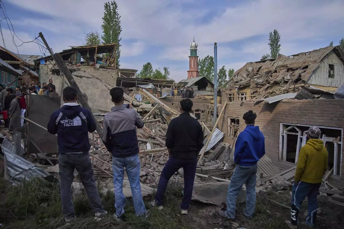 Kashmiri villagers inspect the debris of the blown-up family home of Ahsan Ul Haq Shiekh, a militant who officials say is involved in the deadly attack on tourists in Pahalgam, at Murran village in Pulwama, south of Srinagar, Indian controlled Kashmir, Saturday, April 26, 2025. (AP Photo/Dar Yasin)