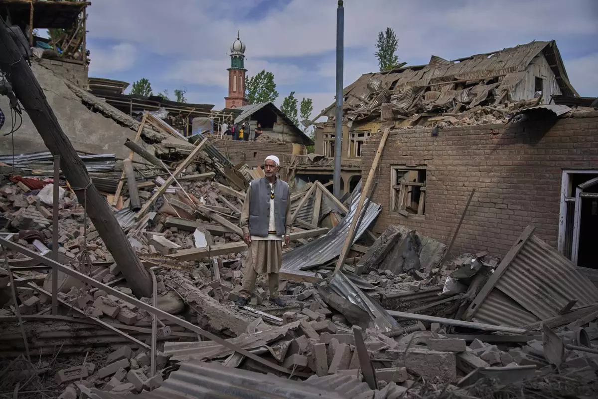 A Kashmiri villager stands amid the debris of the blown-up family home of Ahsan Ul Haq Shiekh, a militant who officials say is involved in the deadly attack on tourists in Pahalgam, at Murran village in Pulwama, south of Srinagar, Indian controlled Kashmir, Saturday, April 26, 2025. (AP Photo/Dar Yasin)