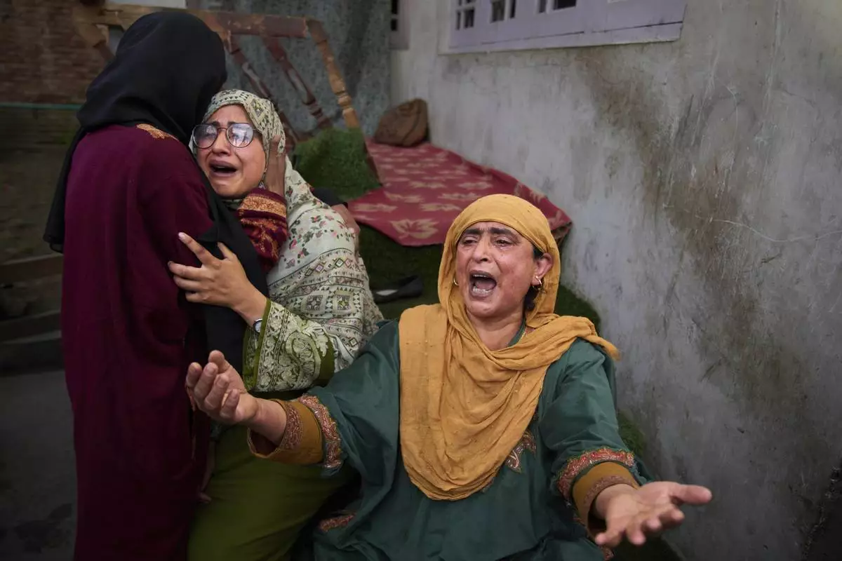 Relatives of Ahsan Ul Haq Shiekh, a militant who officials say is involved in the deadly attack on tourists in Pahalgam, wail after after Indian forces blew up the family home at Murran village in Pulwama, south of Srinagar, Indian controlled Kashmir, Saturday, April 26, 2025. (AP Photo/Dar Yasin)