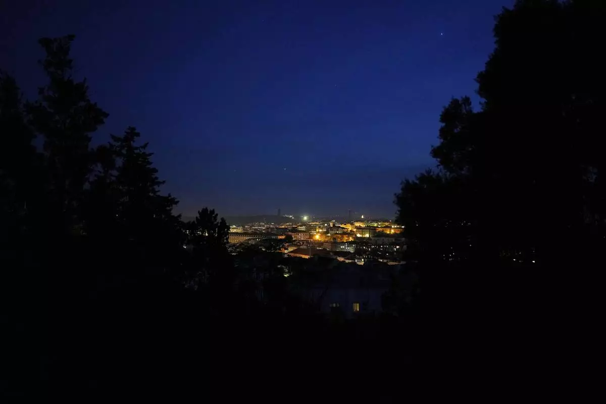 Stars can be seen in the sky above Lisbon, where most buildings had no lights during a nationwide power outage, Monday night, April 28, 2025. (AP Photo/Armando Franca)