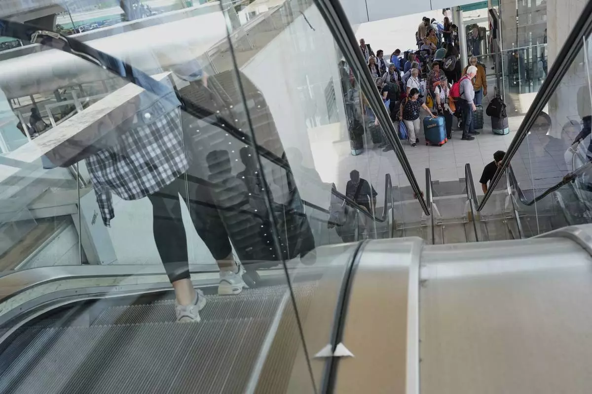 Passengers inside Lisbon Airport during a nationwide power outage in Lisbon, Monday, April 28, 2025. (AP Photo/Armando Franca)