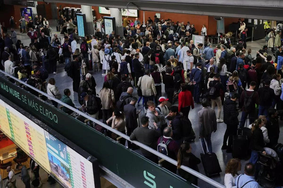 Passengers inside Atocha train station the day after a major power outage in Madrid, Tuesday, April 29, 2025. (AP Photo/Manu Fernandez)