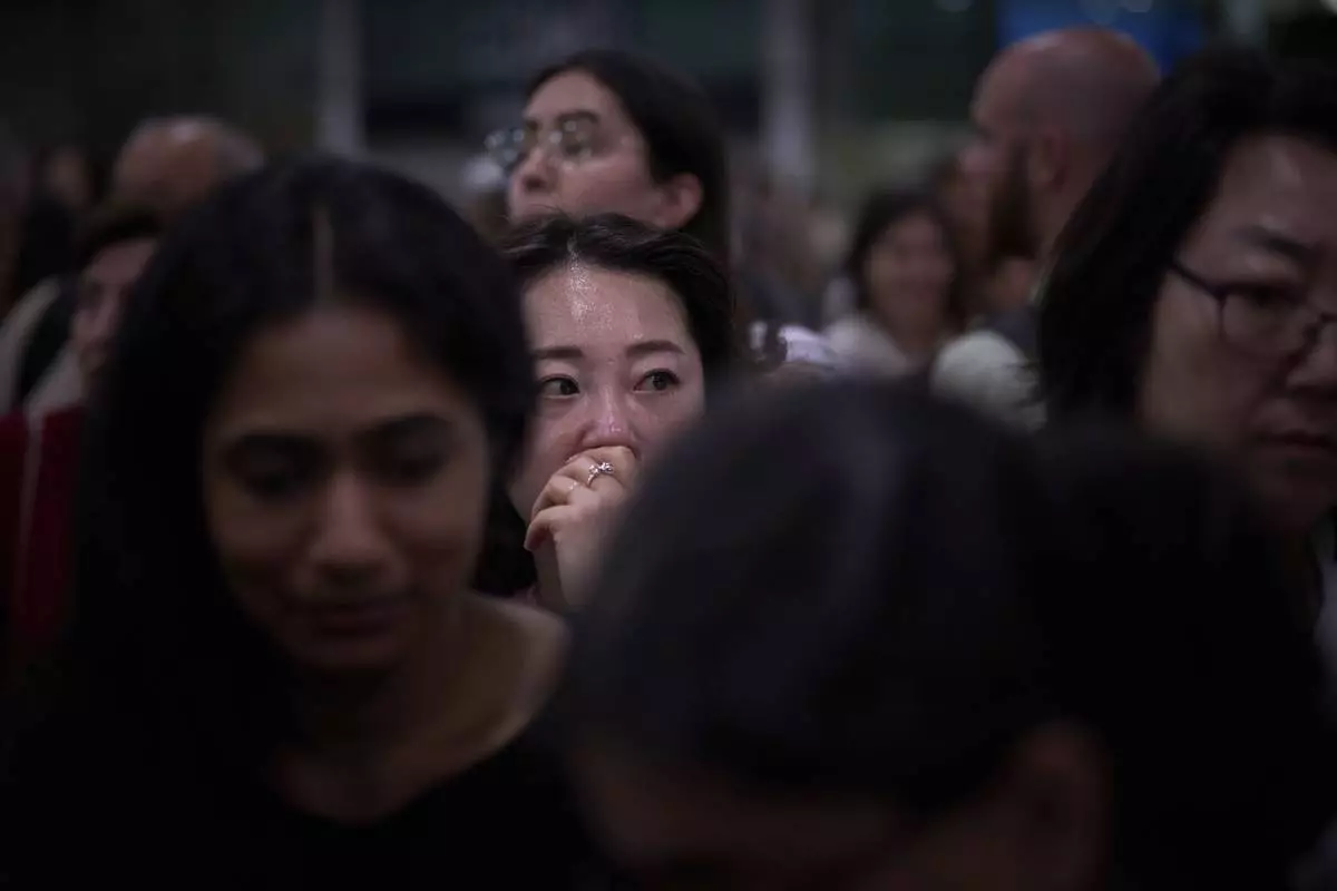Passengers react as they wait for news of train departures, at Sants train station in Barcelona, Spain, Tuesday, April 29, 2025. (AP Photo/Emilio Morenatti)