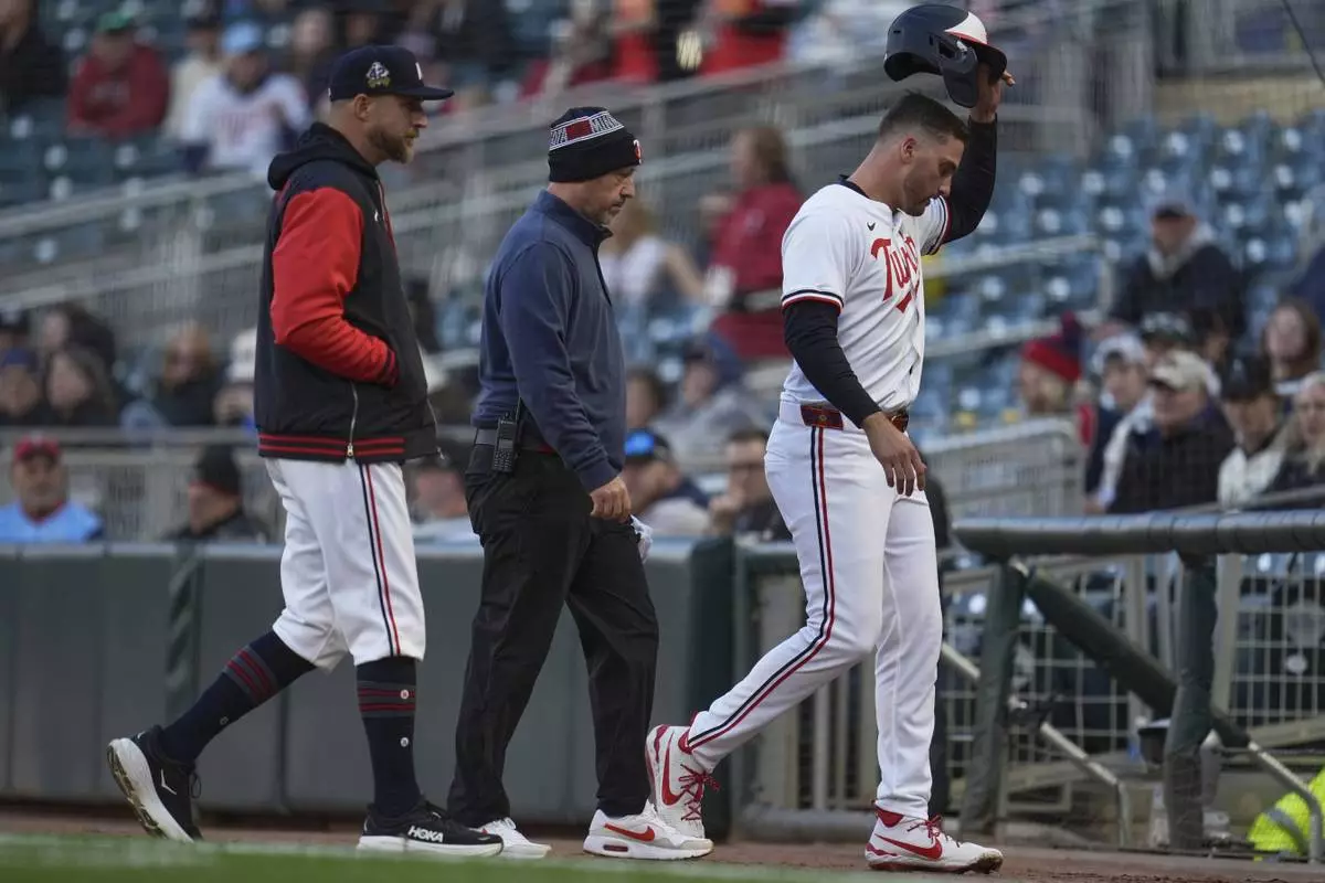 Minnesota Twins' Matt Wallner (38), right, leaves the game with manager Rocco Baldelli and a trainer after sustaining an injury during the first inning of a baseball game against the New York Mets, Tuesday, April 15, 2025, in Minneapolis. (AP Photo/Abbie Parr)