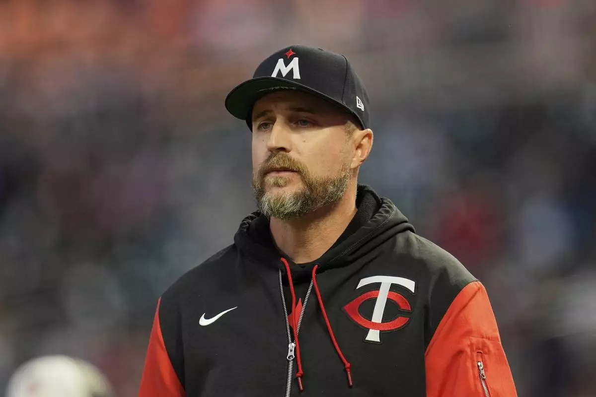 Minnesota Twins manager Rocco Baldelli walks to check on Carlos Correa after sustaining an injury during the fifth inning of a baseball game against the New York Mets, Tuesday, April 15, 2025, in Minneapolis. (AP Photo/Abbie Parr)