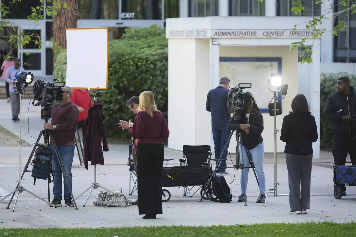 Media stage outside the Van Nuys West Courthouse before a hearing regarding the case of Erik and Lyle Menendez Friday, April 11, 2025, in Los Angeles. (AP Photo/Damian Dovarganes)