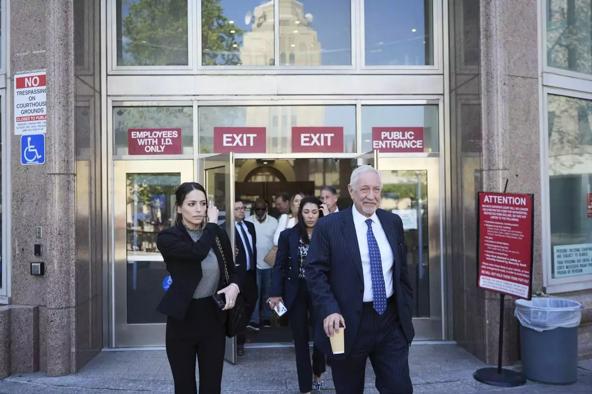 Attorney Mark Geragos exits for a lunch break during a hearing regarding the case of Erik and Lyle Menendez Friday, April 11, 2025, in Los Angeles. (AP Photo/Damian Dovarganes)