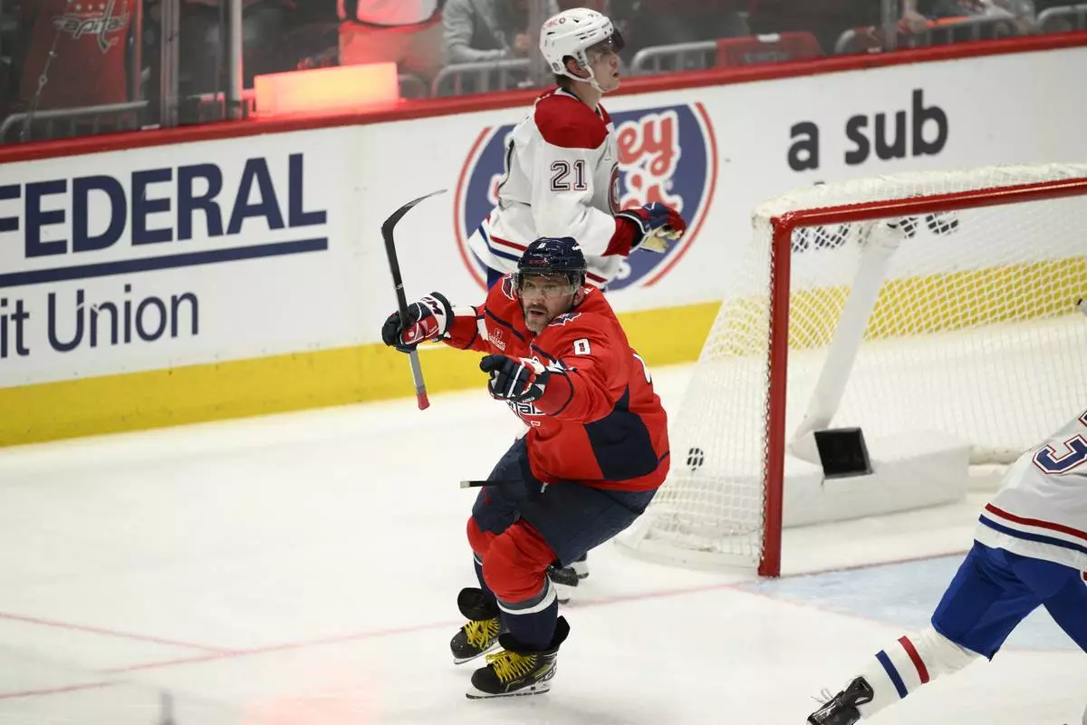 Washington Capitals left wing Alex Ovechkin (8) celebrates after his winning goal as Montreal Canadiens defenseman Kaiden Guhle (21) looks on in overtime of Game 1 of a first-round NHL hockey playoff series Monday, April 21, 2025, in Washington. (AP Photo/Nick Wass)