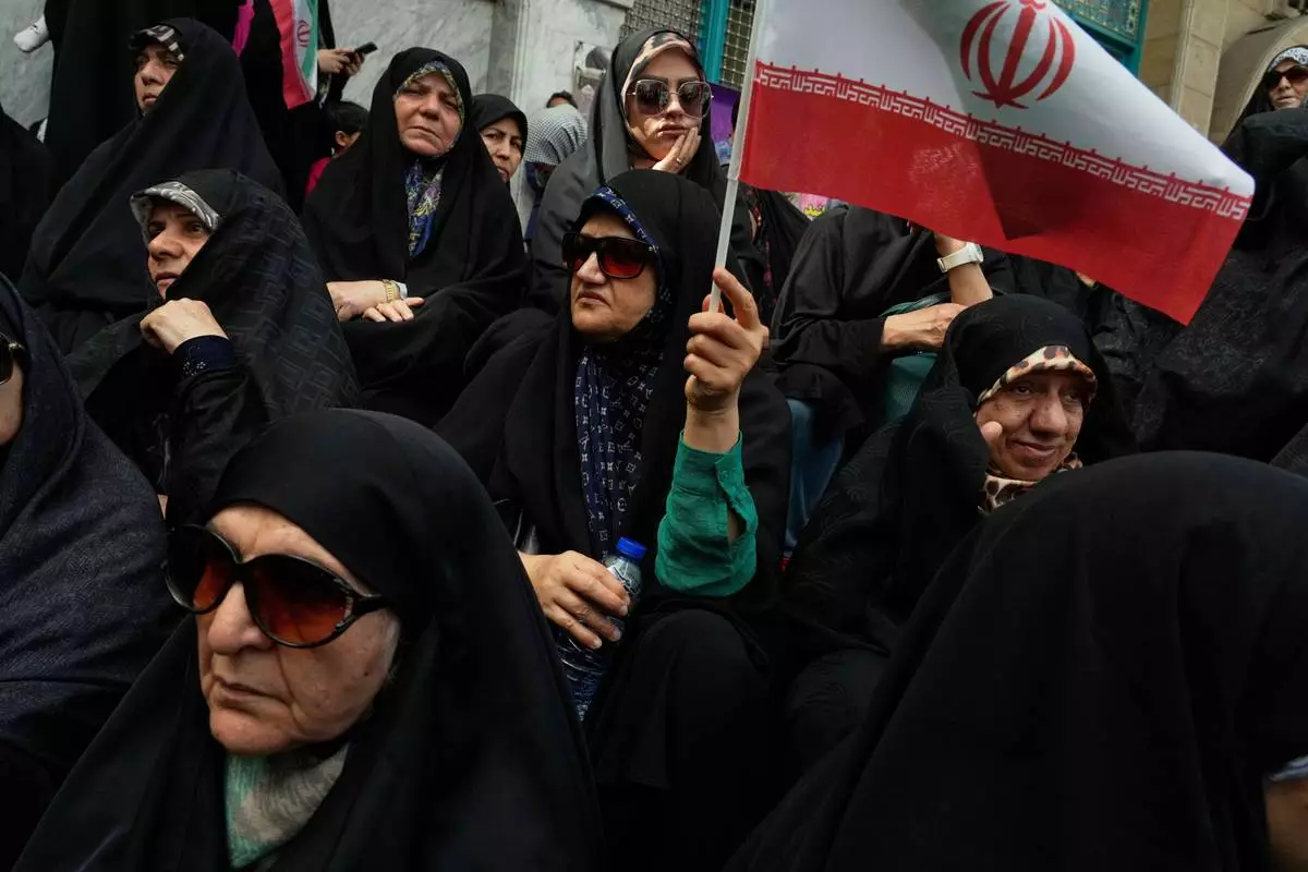 An Iranian protester waves her country's flag during an anti-Israeli demonstration at the Felestin (Palestine) Sq. in Tehran, Iran, Wednesday, April 9, 2025. (AP Photo/Vahid Salemi)