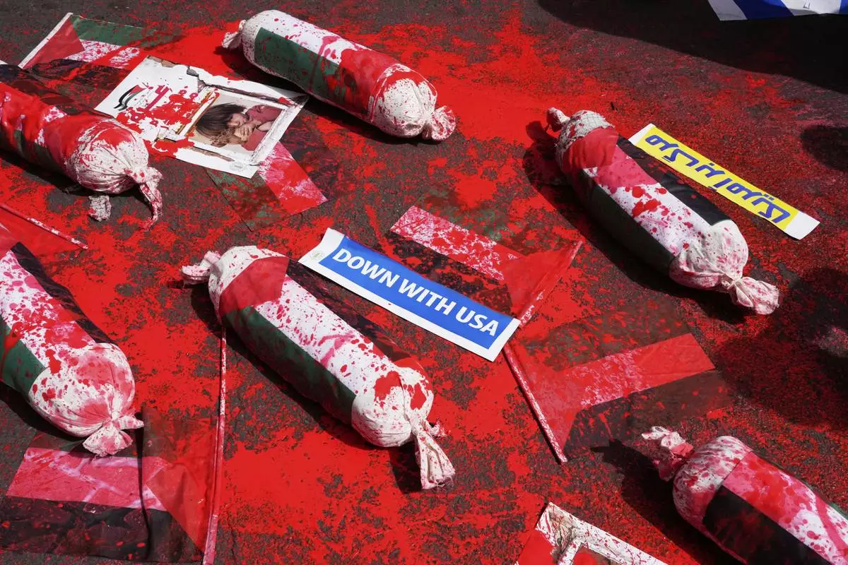 The symbolic shrouded bodies of Palestinian children are displayed during an anti-Israel demonstration at the Felestin (Palestine) Sq. in Tehran, Iran, Wednesday, April 9, 2025. (AP Photo/Vahid Salemi)
