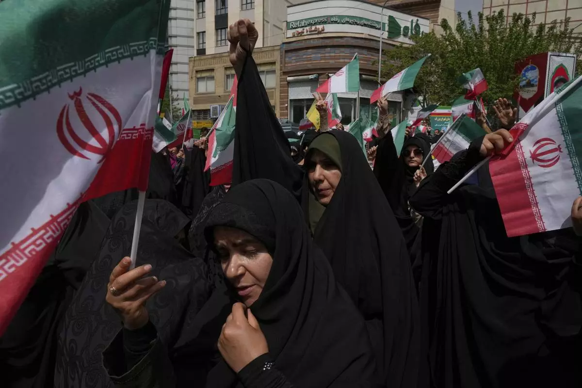 Iranian protesters chant slogans as they wave their country's flags during an anti-Israel demonstration at the Felestin (Palestine) Sq. in Tehran, Iran, Wednesday, April 9, 2025. (AP Photo/Vahid Salemi)