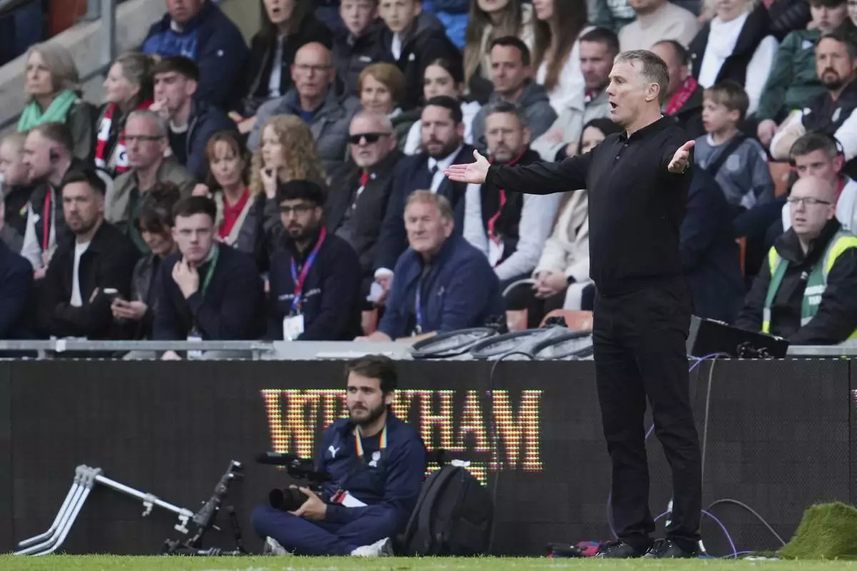 Wrexham's Manager Phil Parkinson reacts during the English League One soccer match between Wrexham and Charlton Athletic at the Racecourse ground in Wrexham, Wales, Saturday, April 26, 2025. (AP Photo/Jon Super)
