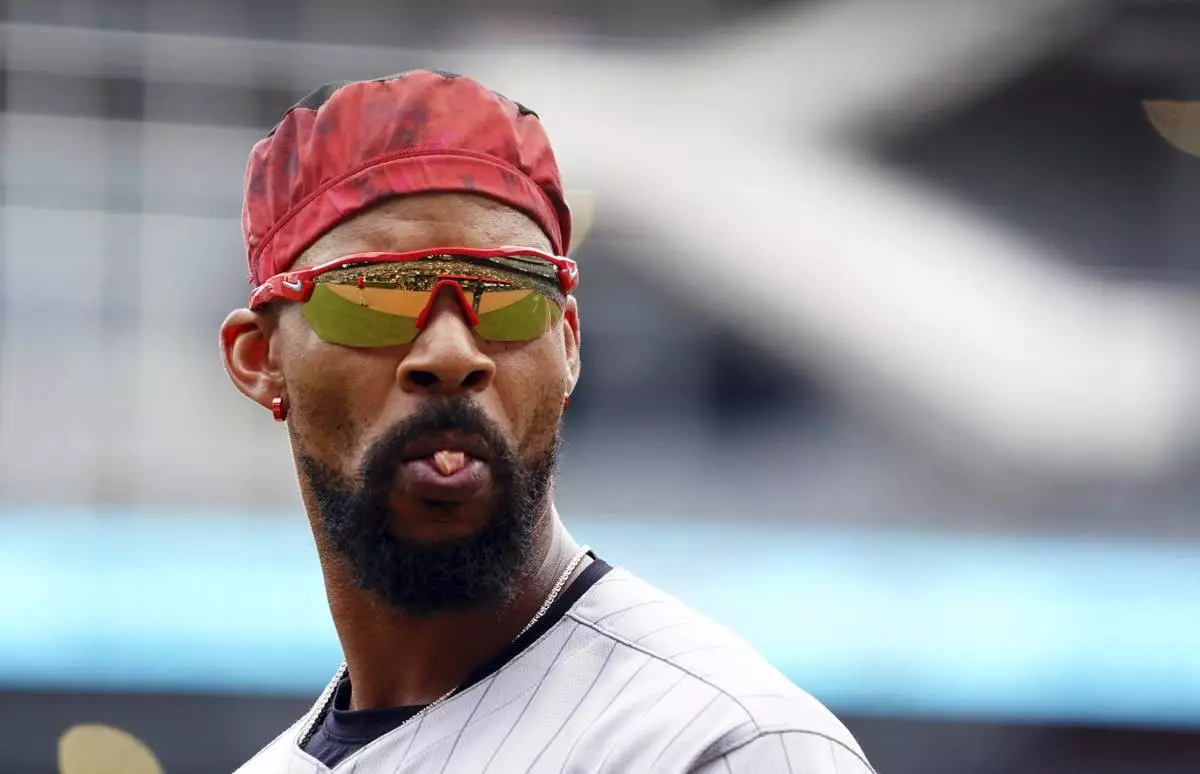 Minnesota Twins outfielder Byron Buxton (25) tries to blow a bubble between innings during a baseball game against the Minnesota Twins, Saturday, April 20, 2025, in Atlanta. (AP Photo/John David Mercer)
