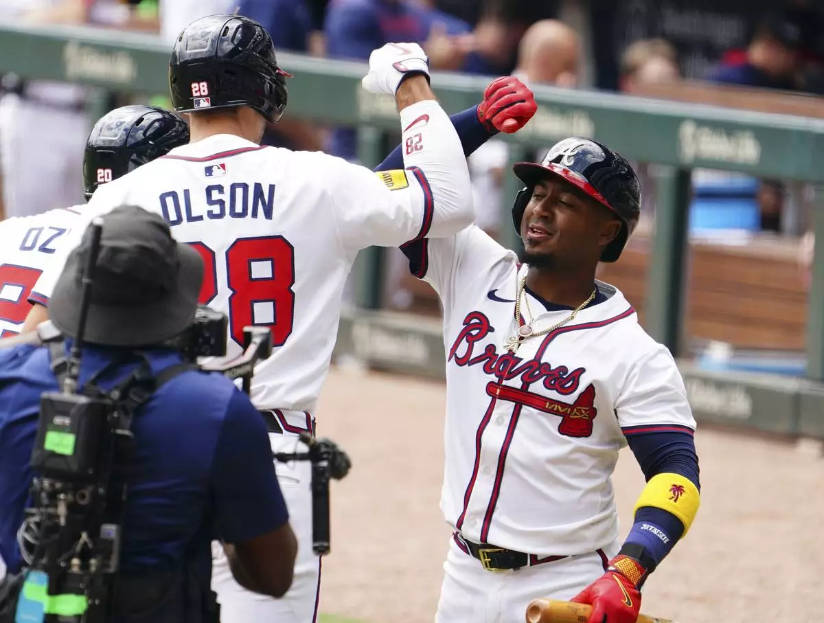 Atlanta Braves' Matt Olson (28) celebrates his two-run home run against the Minnesota Twins with teammate Ozzie Albies (1) during the first inning of a baseball game Saturday, April 20, 2025, in Atlanta. (AP Photo/John David Mercer)