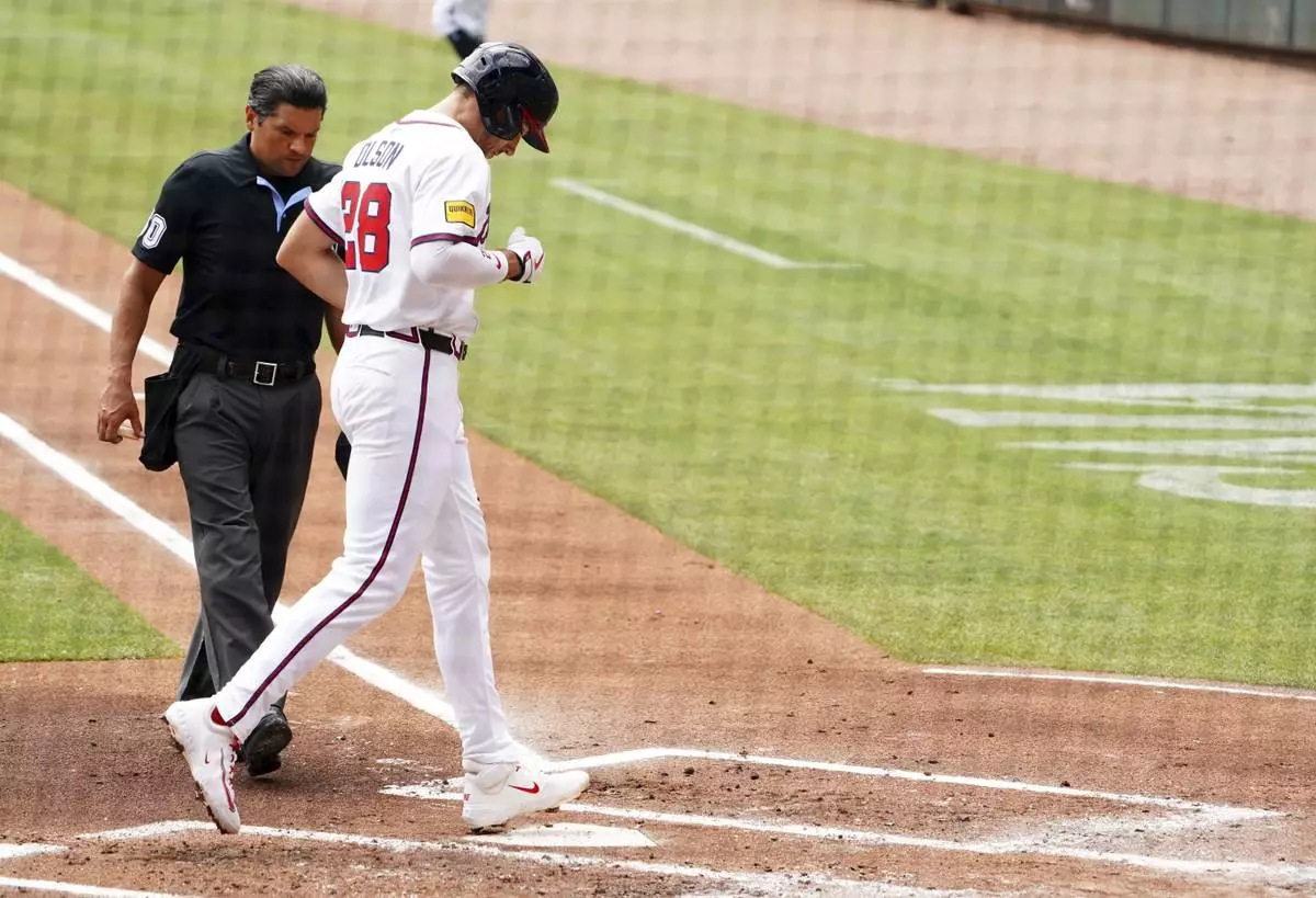 Atlanta Braves' Matt Olson (28) touches home plate after his two-run home run against the Minnesota Twins during the first inning of a baseball game Saturday, April 20, 2025, in Atlanta. (AP Photo/John David Mercer)