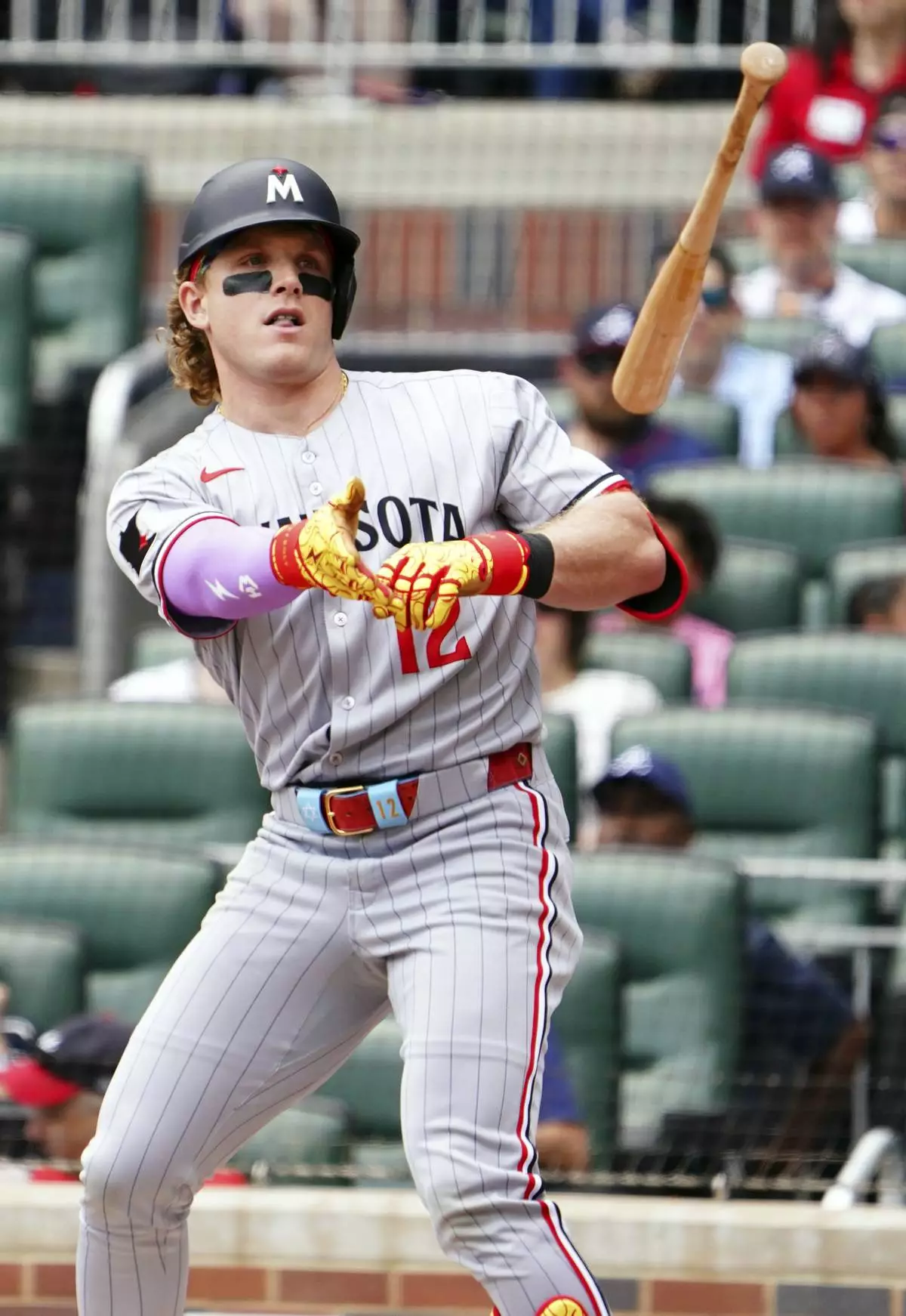 Minnesota Twins' Harrison Bader (12) tosses his bat heading to first base during the third inning of a baseball game against the Atlanta Braves, Saturday, April 20, 2025, in Atlanta. (AP Photo/John David Mercer)