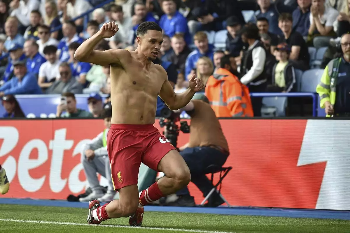 Liverpool's Trent Alexander-Arnold celebrates after scoring his side's opening goal during the English Premier League soccer match between Leicester City and Liverpool at King Power stadium in Leicester, England, Sunday, April 20, 2025. (AP Photo/Rui Vieira)