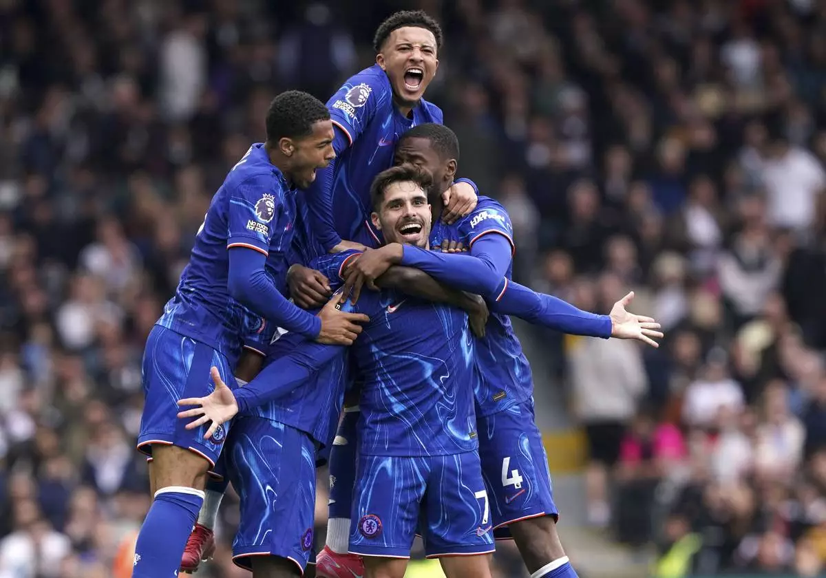 Chelsea's Pedro Neto, center, celebrates scoring his side's second goal of the game with teammates, during the English Premier League soccer match between Fulham and Chelsea, at Craven Cottage, London, Sunday April 20, 2025. (Jonathan Brady/PA via AP)