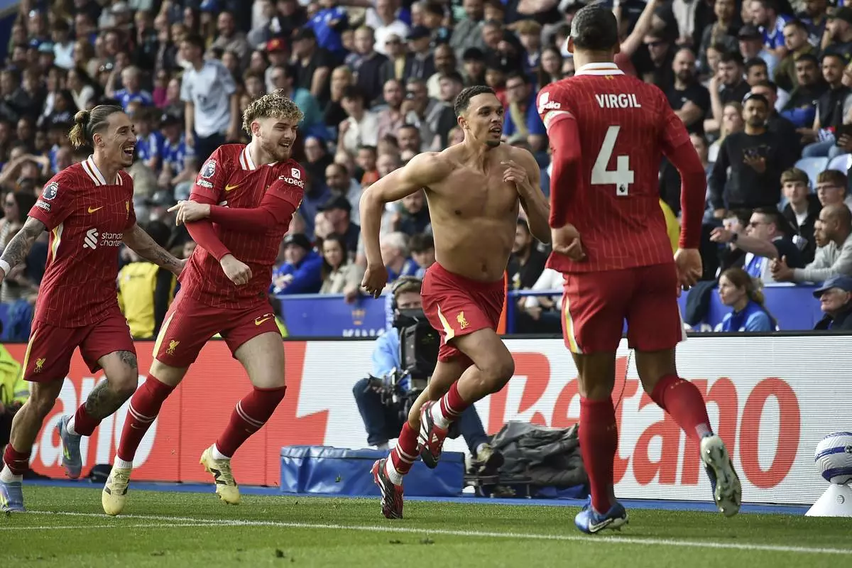Liverpool's Trent Alexander-Arnold, second right, celebrates after scoring his side's opening goal during the English Premier League soccer match between Leicester City and Liverpool at King Power stadium in Leicester, England, Sunday, April 20, 2025. (AP Photo/Rui Vieira)
