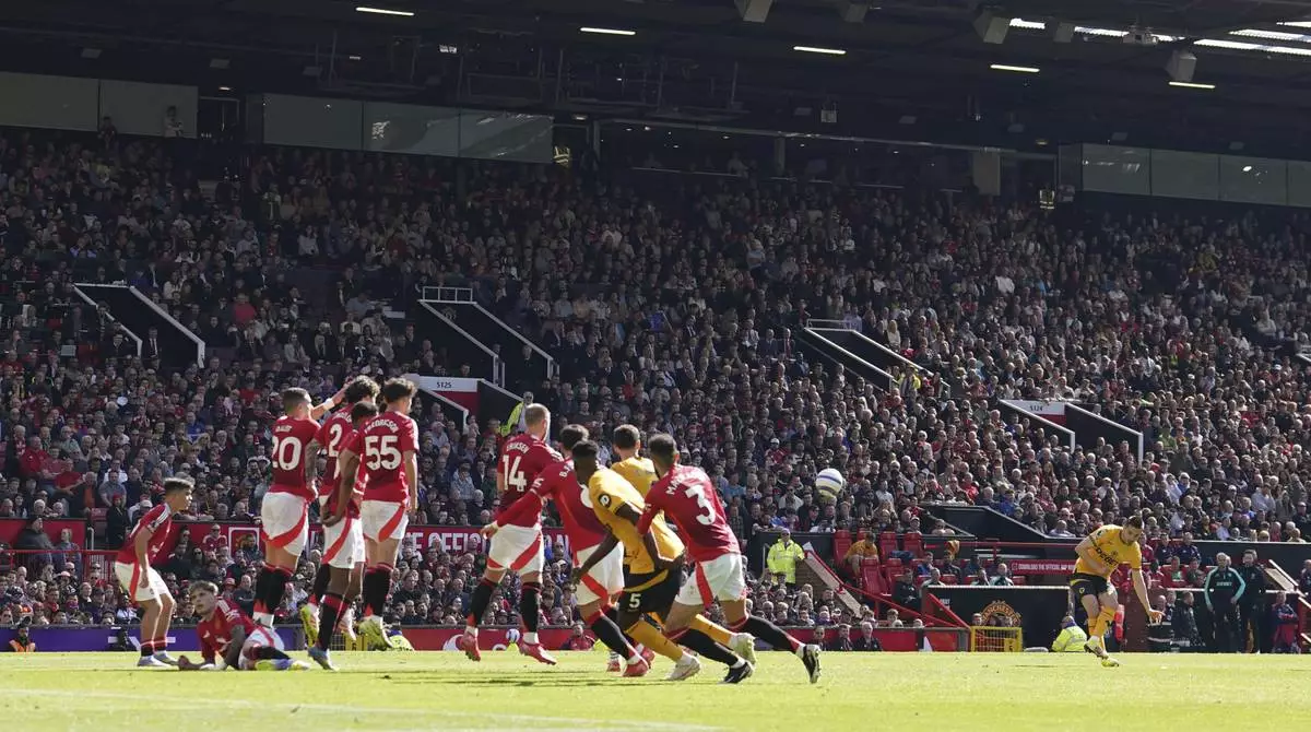 Wolverhampton Wanderers' Pablo Sarabia, second from right, scores his side's first goal of the game, during the English Premier League soccer match between Manchester United and Wolverhampton Wanderers, at Old Trafford, Manchester, England, Sunday, April 20, 2025. (Martin Rickett/PA via AP)