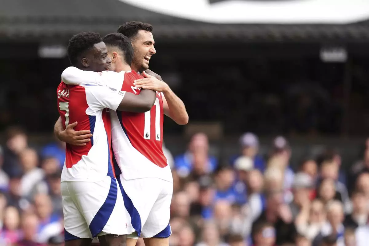 Arsenal's Gabriel Martinelli celebrates scoring his side's second goal of the game with teammates, during the English Premier League soccer match between Ipswich Town and Arsenal at Portman Road, Ipswich, England, Sunday, April 20, 2025. (John Walton/PA via AP)