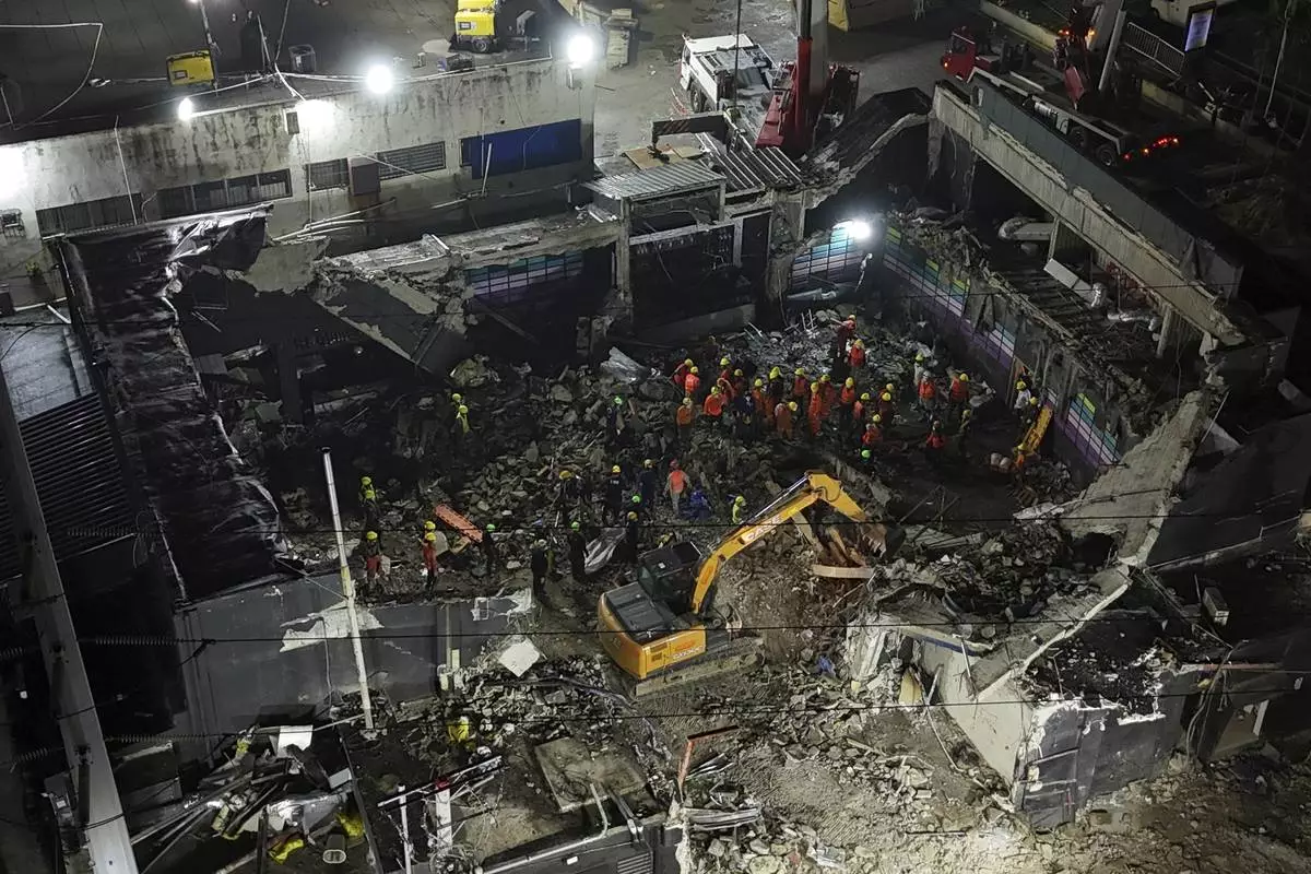 Rescue workers search for bodies at the Jet Set nightclub after its roof collapsed during a merengue concert in Santo Domingo, Dominican Republic, Thursday, April 10, 2025. (AP Photo/Matias Delacroix)