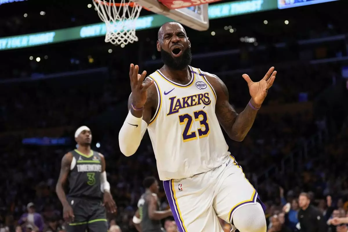 Los Angeles Lakers forward LeBron James, right, reacts after missing a pass during the first half in Game 1 of an NBA first-round playoff series against the Minnesota Timberwolves Saturday, April 19, 2025, in Los Angeles. (AP Photo/Mark J. Terrill)