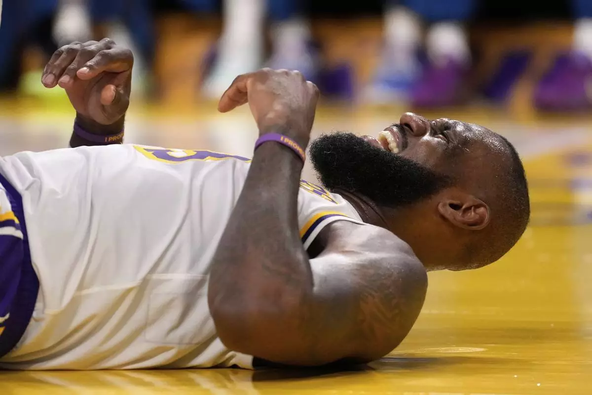 Los Angeles Lakers forward LeBron James reacts after being hit in the face by Minnesota Timberwolves forward Julius Randle as Randle was shooting during the second half in Game 1 of an NBA first-round playoff series Saturday, April 19, 2025, in Los Angeles. (AP Photo/Mark J. Terrill)