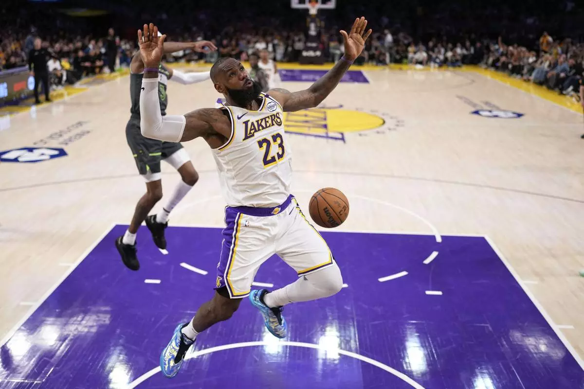 Los Angeles Lakers forward LeBron James dunks during the second half in Game 1 of an NBA first-round playoff series against the Minnesota Timberwolves, Saturday, April 19, 2025, in Los Angeles. (AP Photo/Mark J. Terrill)