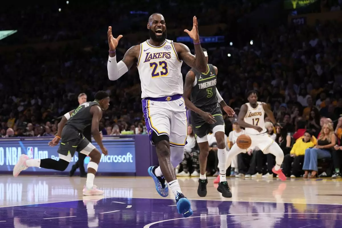 Los Angeles Lakers forward LeBron James, right, reacts after missing a pass during the first half in Game 1 of an NBA first-round playoff series against the Minnesota Timberwolves Saturday, April 19, 2025, in Los Angeles. (AP Photo/Mark J. Terrill)