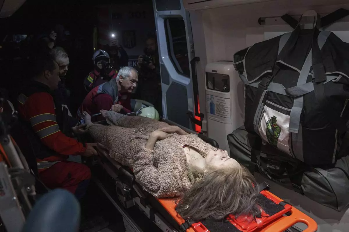 Medics tend to an injured woman in an ambulance near a house destroyed by a Russian airstrike in a residential neighbourhood in Kyiv, Ukraine, on Thursday, April 24, 2025. (AP Photo/Evgeniy Maloletka)