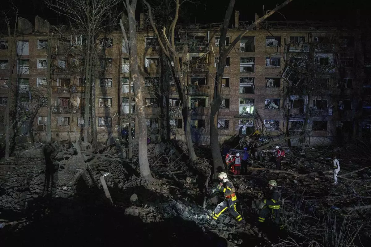 Rescue workers clear the rubble at a house damaged by a Russian airstrike in a residential neighborhood in Kyiv, Ukraine, on Thursday, April 24, 2025. (AP Photo/Evgeniy Maloletka)