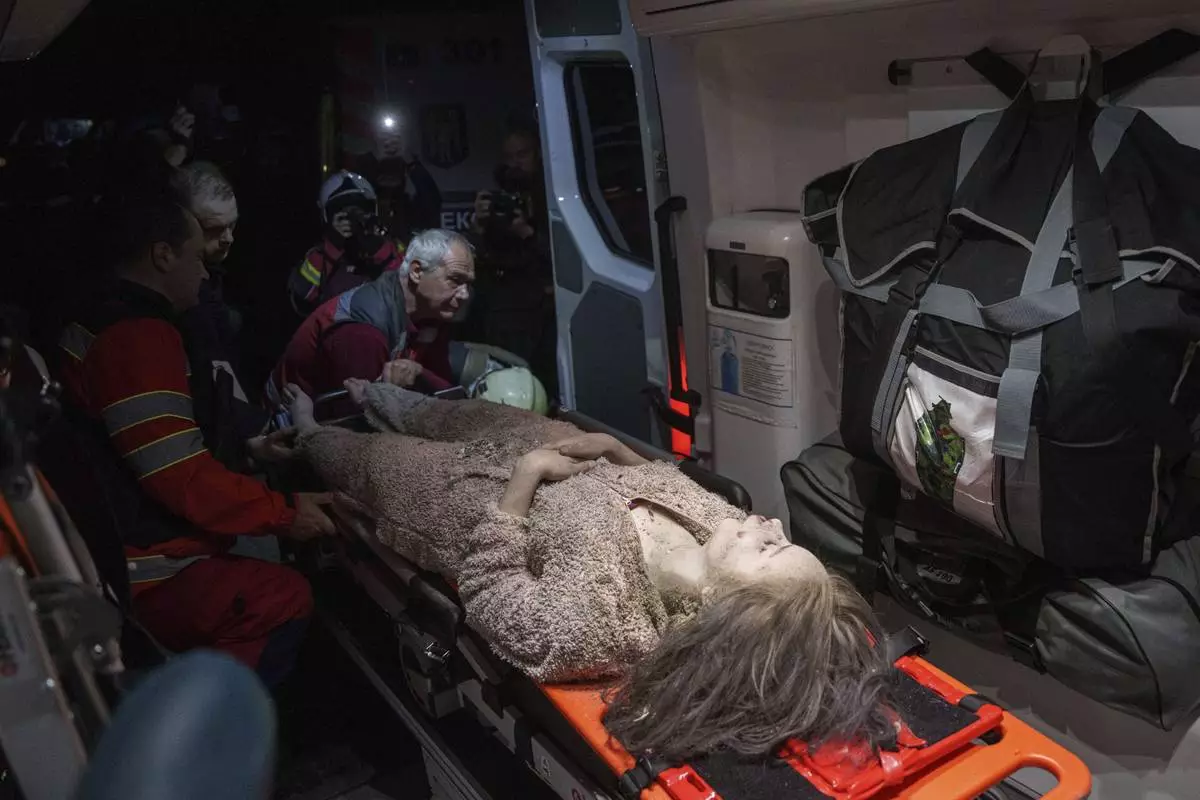 Medics tend to an injured woman in an ambulance near a house destroyed by a Russian airstrike in a residential neighbourhood in Kyiv, Ukraine, on Thursday, April 24, 2025. (AP Photo/Evgeniy Maloletka)
