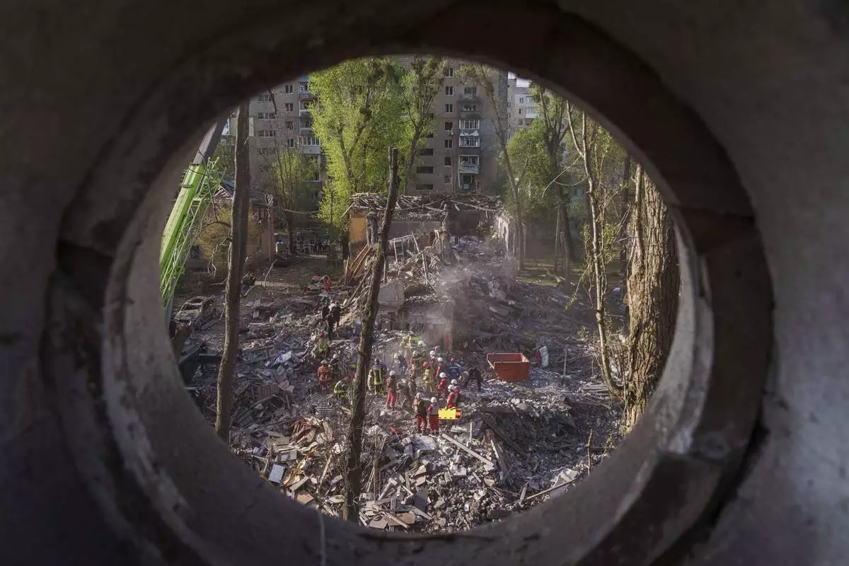 Rescue workers clear the rubble of a house destroyed by a Russian strike on a residential neighbourhood in Kyiv, Ukraine, on Thursday, April 24, 2025. (AP Photo/Evgeniy Maloletka)
