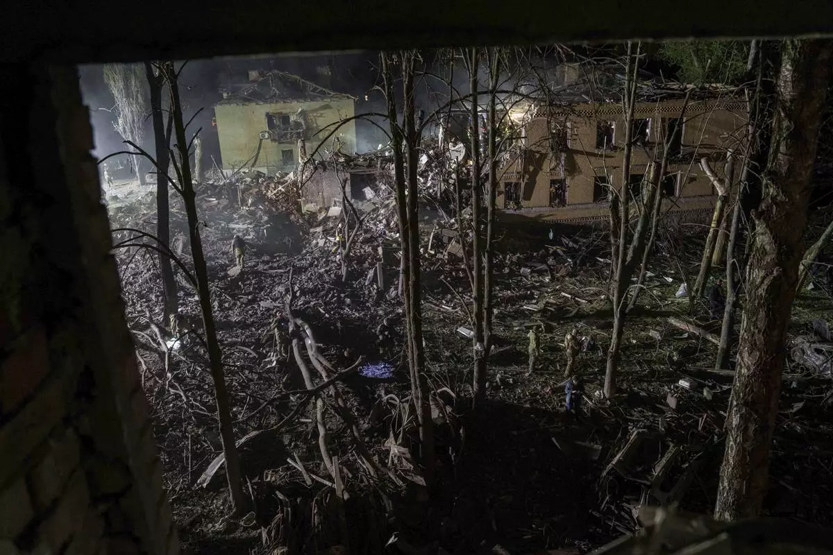 Rescue workers clear the rubble of a house destroyed by a Russian airstrike in a residential neighborhood in Kyiv, Ukraine, on Thursday, April 24, 2025. (AP Photo/Evgeniy Maloletka)