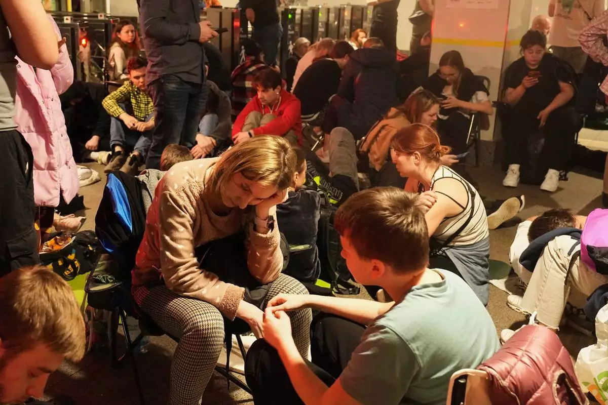 People rest in a metro station, being used as a bomb shelter, during a Russian missile attack in Kyiv, Ukraine, early Thursday, April 24, 2025. (AP Photo/Efrem Lukatsky)
