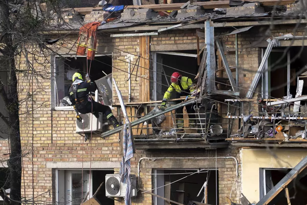 Rescue workers clear the rubble from a house heavily damaged after a Russian strike in a residential neighborhood in Kyiv, Ukraine, Thursday, April 24, 2025. (AP Photo/Alex Babenko)