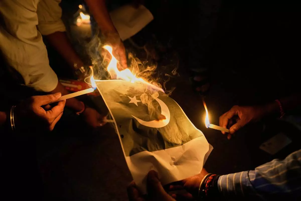 People burn Pakistani flags during a protest against the killing of tourists by militants near Pahalgam in Indian controlled Kashmir, in Guwahati, India, Thursday, April 24, 2025. (AP Photo/Anupam Nath)