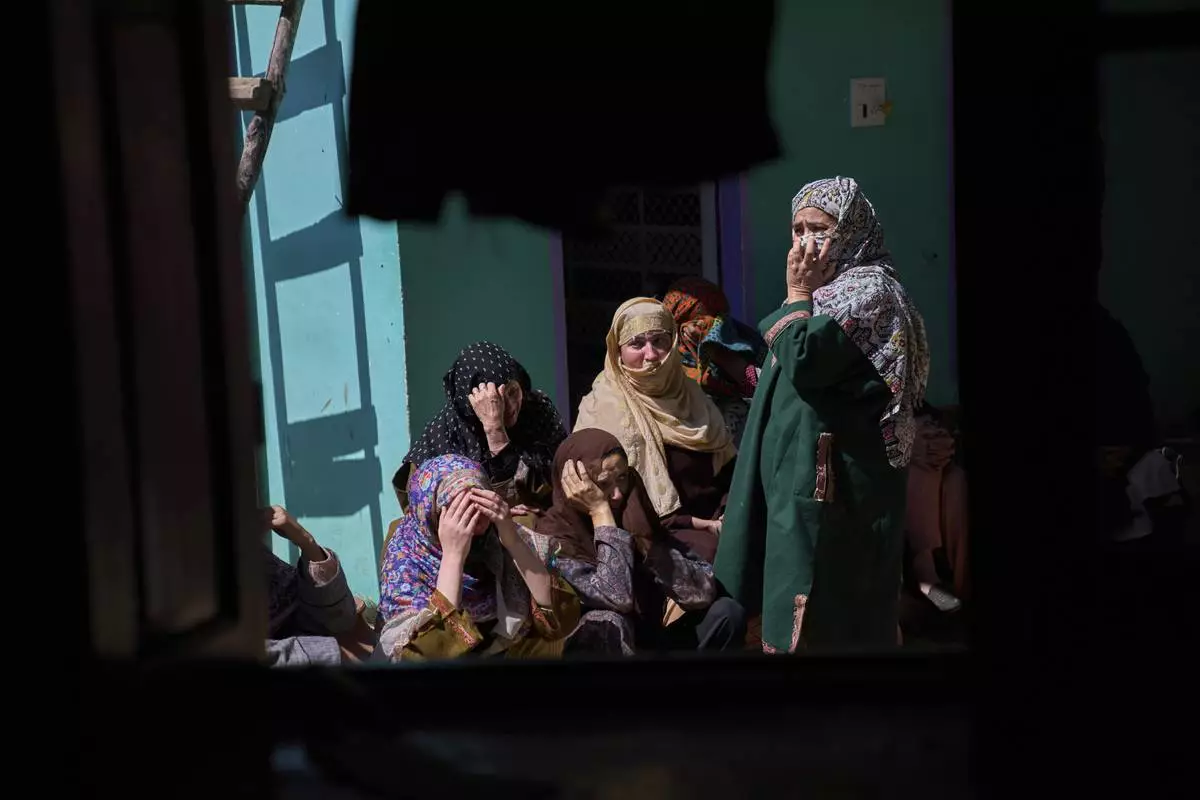 Kashmiri villager women grieve as they sit outside the blown-up family home of Asif Shiekh, a militant who officials say is involved in the deadly attack on tourists in Pahalgam, at Monghama village in Tral, south of Srinagar, Indian controlled Kashmir, Friday, April 25, 2025. (AP Photo/Dar Yasin)