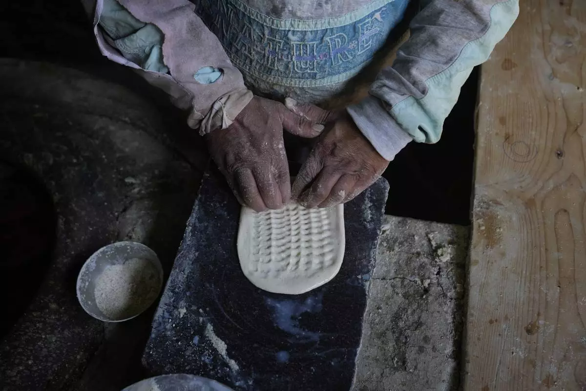 A Kashmiri baker works inside his shop in Srinagar, Indian controlled Kashmir, Thursday, April 24, 2025. (AP Photo/Mukhtar Khan)