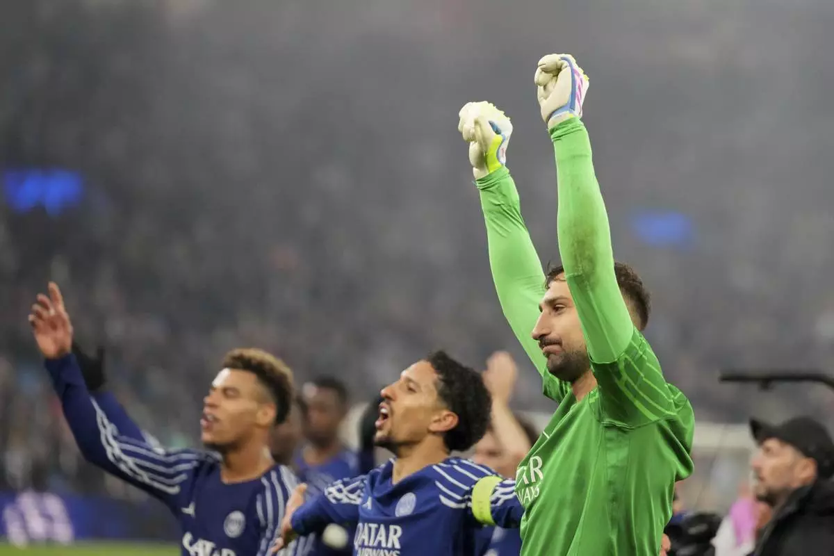 PSG's goalkeeper Gianluigi Donnarumma and team mates applaud fans at the end of the Champions League quarterfinal second leg soccer match between Aston Villa and Paris Saint-Germain at the Villa Park stadium, in Birmingham, England, Tuesday, April 15, 2025. (AP Photo/Frank Augstein)